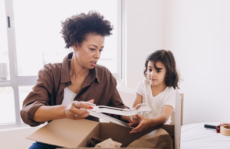 Mom and Daughter packing a box