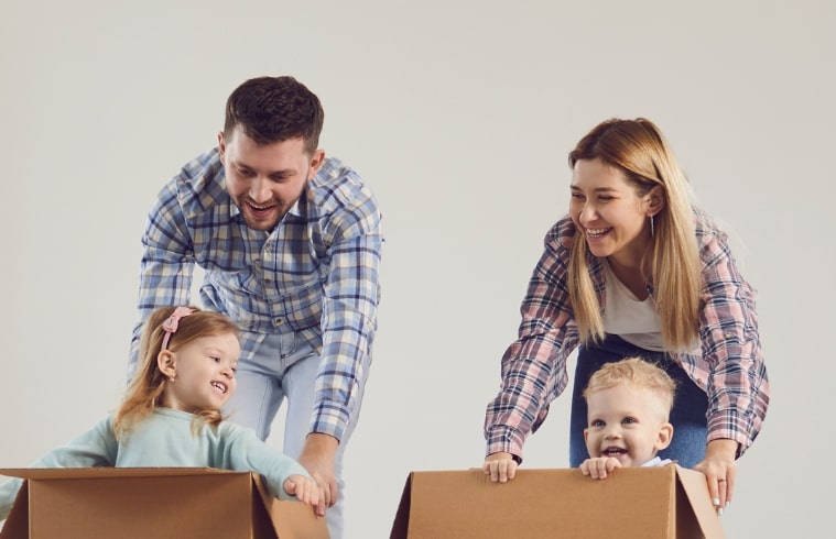 Mom and Dad pushing kids in boxes
